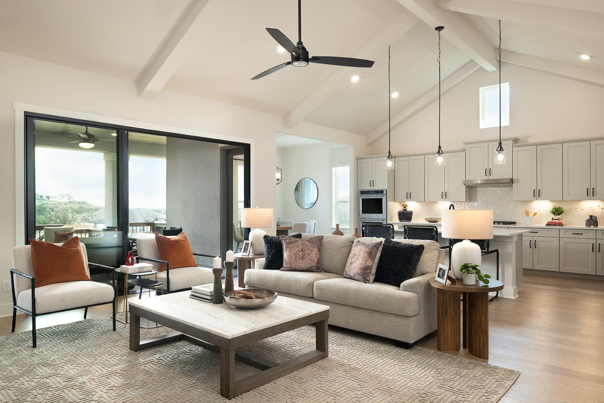 great room with couch, rug & large windows