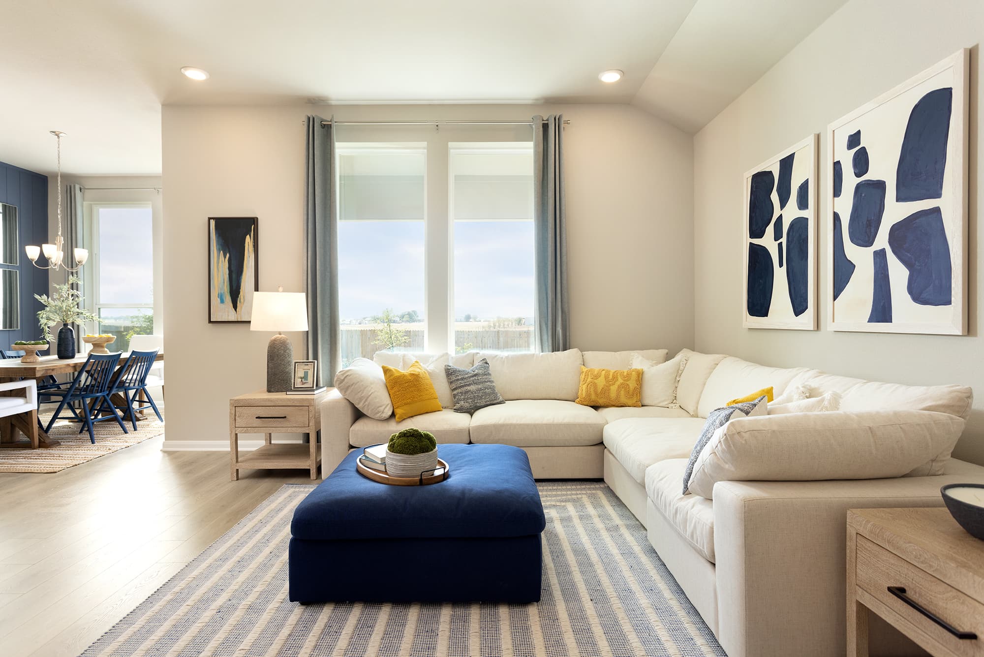 living room with wood flooring, couches & windows