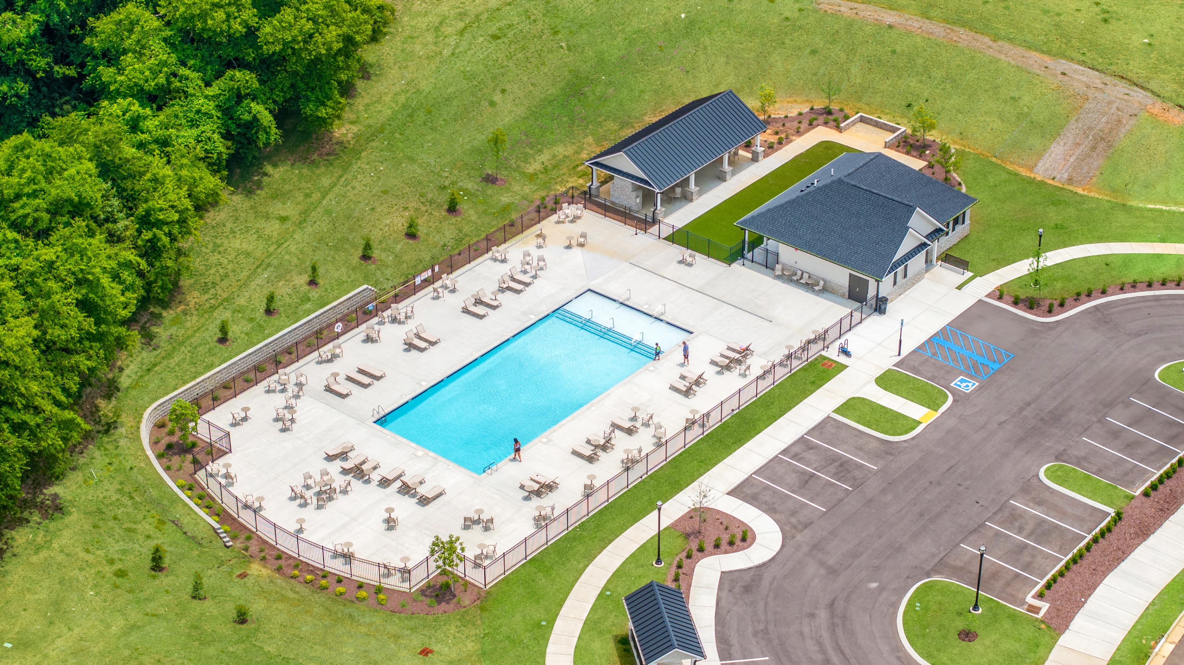 amenities with pool, clubhouse, and green space