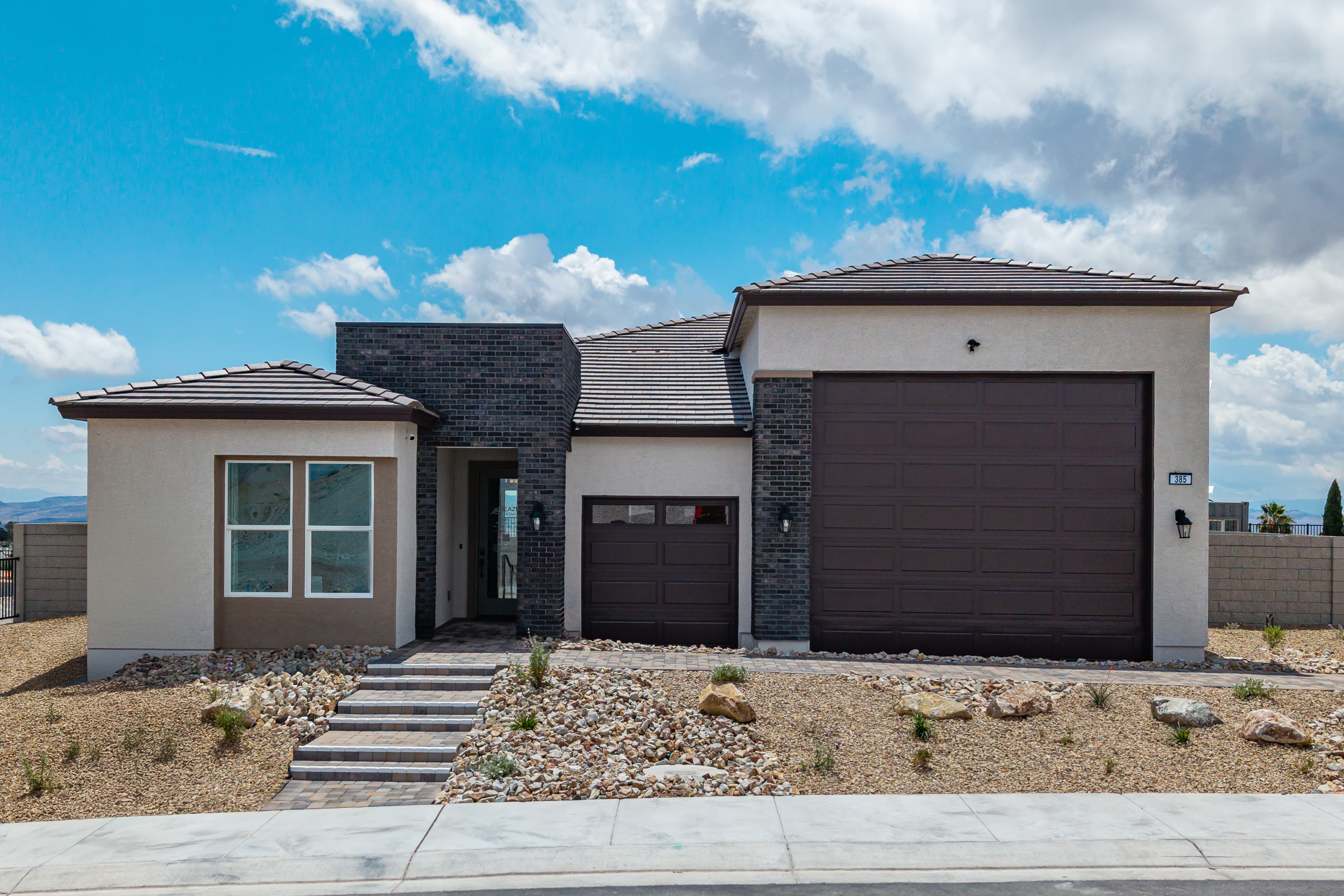 single-story home with brick pavers and rv garage 