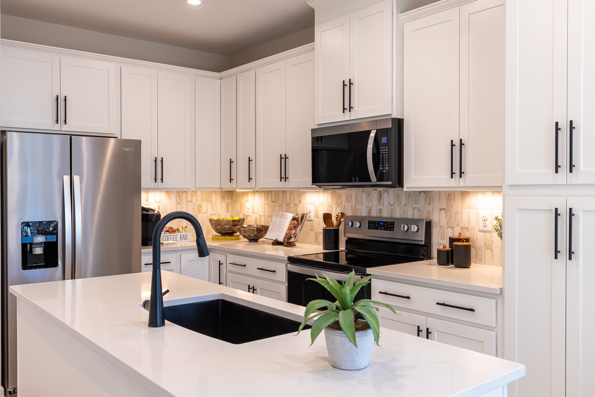 kitchen with white cabiners and stainless steel appliances