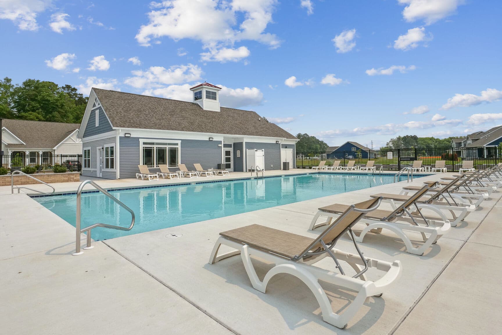 community pool with lounge chairs